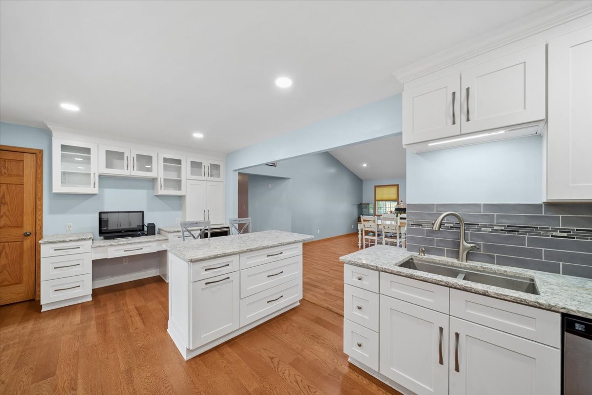 2 Division Street Bristol, IL 60512 - Photo 9 of 44 a kitchen with white cabinets and sink