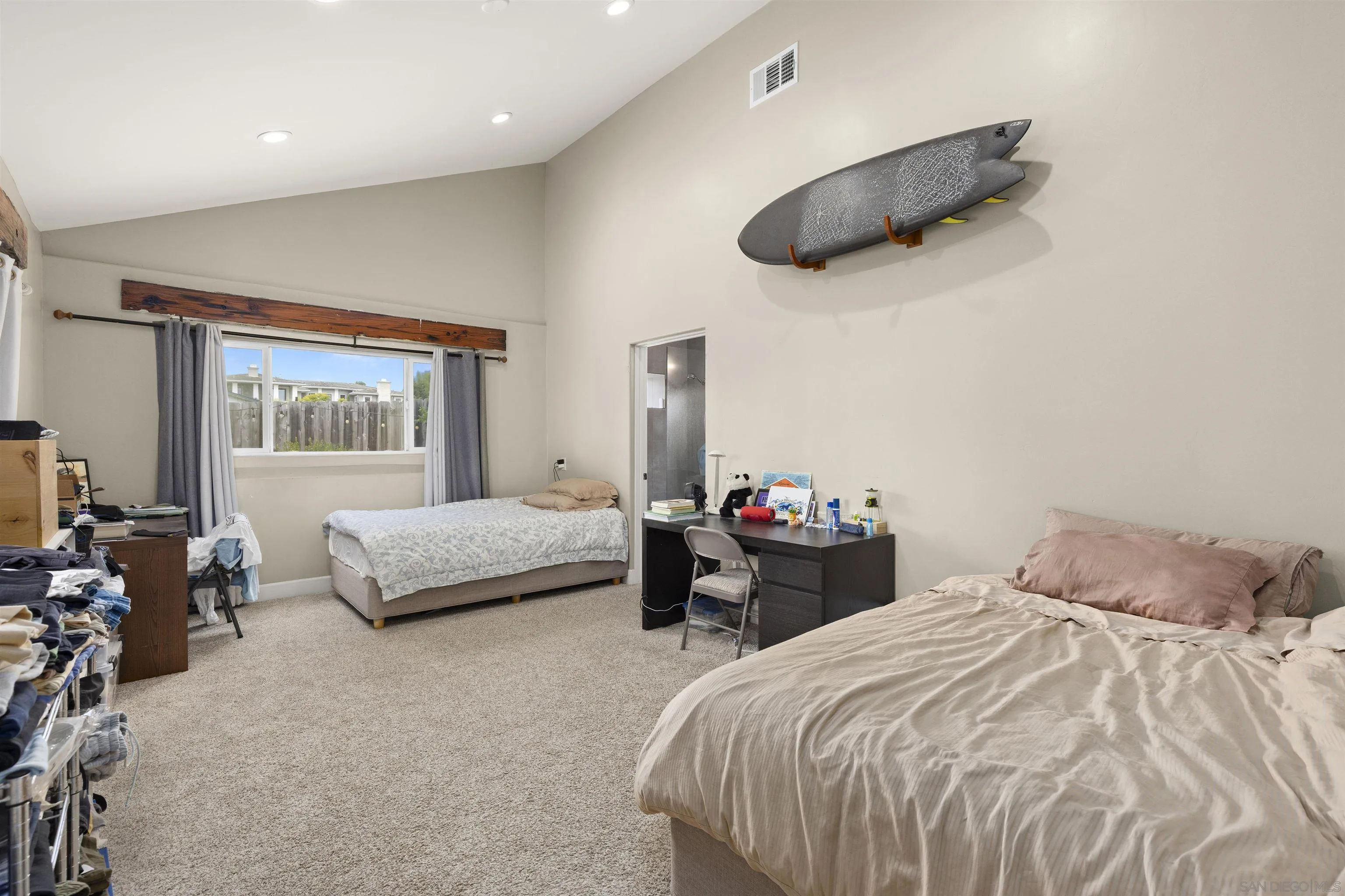 752 Bracero Road Encinitas, CA 92024 - Photo 26 of 46 a bedroom with a bed and a chandelier