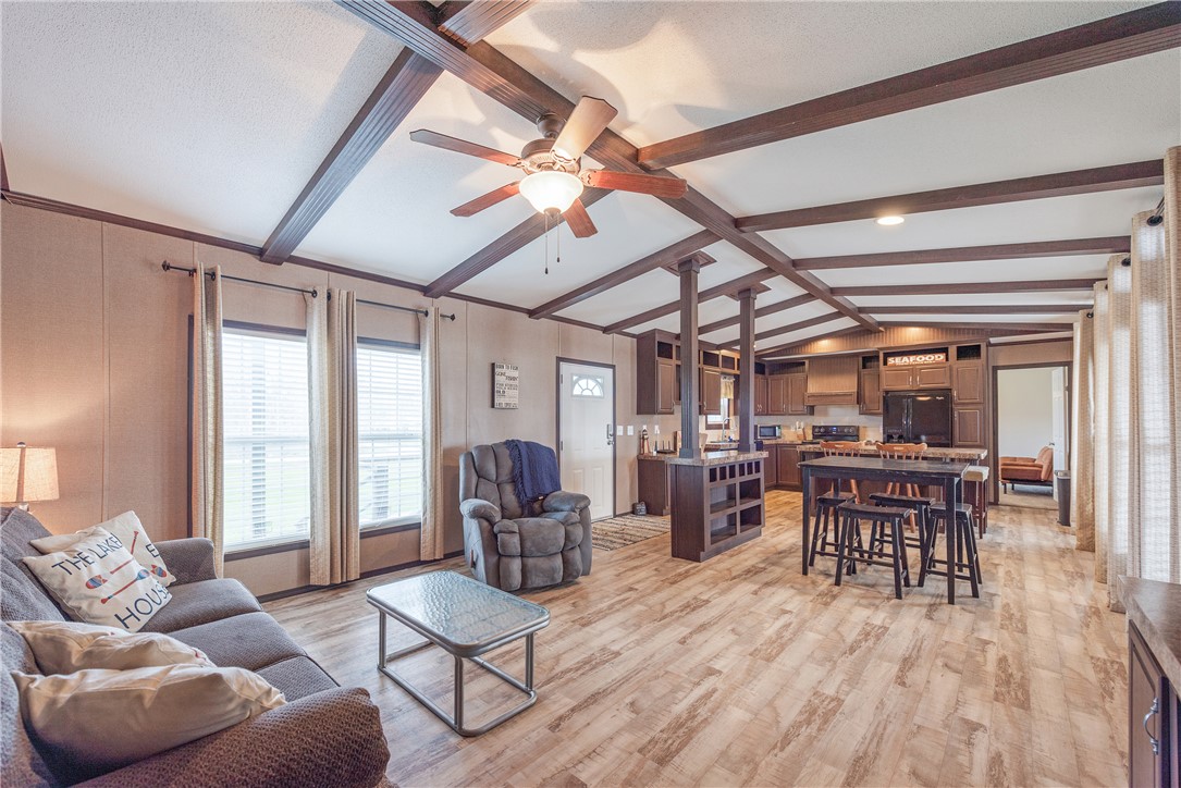 398 River Oaks Drive Trinity, TX 75862 - Photo 6 of 21 a living room with furniture dining table a large window and potted plants