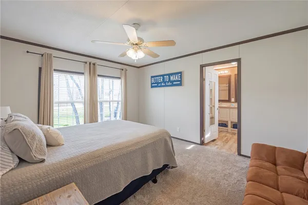 a bedroom with a bed couch and window