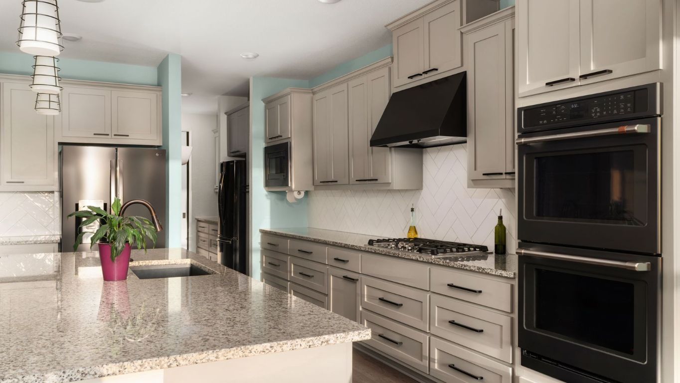 1925 Sorvino Walk Leander, TX 78641 - Photo 11 of 36 a kitchen with stainless steel appliances kitchen island granite countertop a stove refrigerator and microwave