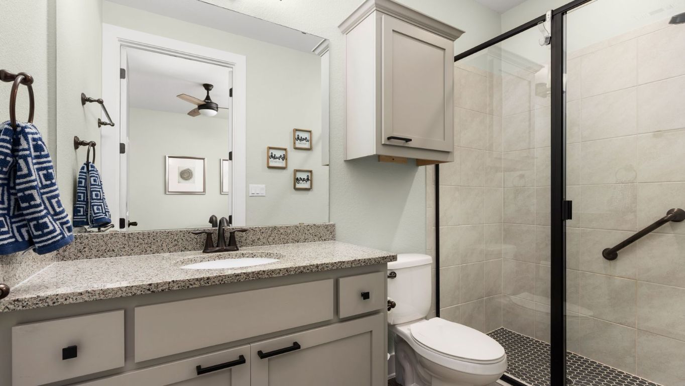 1925 Sorvino Walk Leander, TX 78641 - Photo 18 of 36 a bathroom with a granite countertop sink toilet and shower