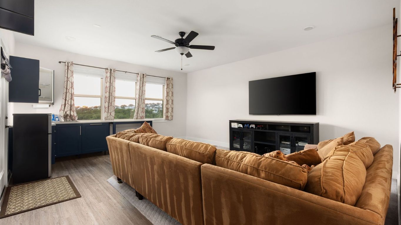 1925 Sorvino Walk Leander, TX 78641 - Photo 21 of 36 a living room with furniture a flat screen tv and a large window