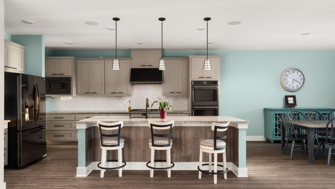 1925 Sorvino Walk Leander, TX 78641 - Photo 10 of 36 a kitchen with stainless steel appliances kitchen island granite countertop a dining table chairs and a view of living room