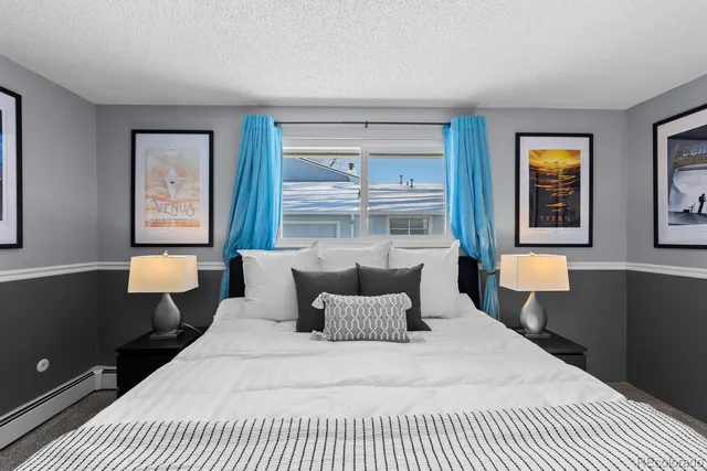 a bedroom with a large bed and lamp