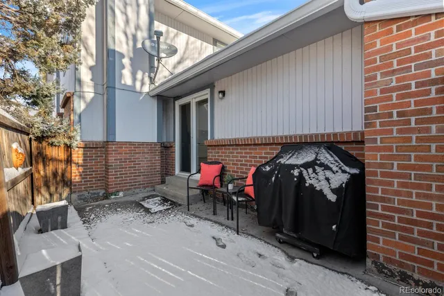 a view of a house with a yard covered in snow