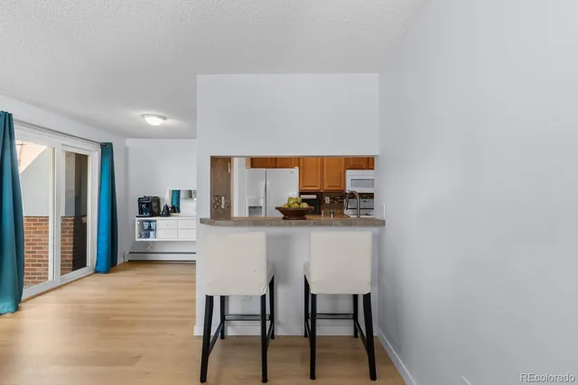 a kitchen with stainless steel appliances a refrigerator and cabinets