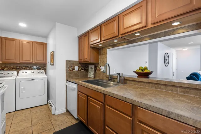 a kitchen with cabinets stainless steel appliances and a counter space