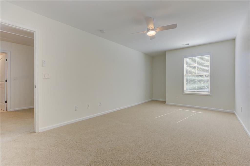 605 Summit Point Canton, GA 30114 - Photo 45 of 56 an empty room with windows and ceiling fan