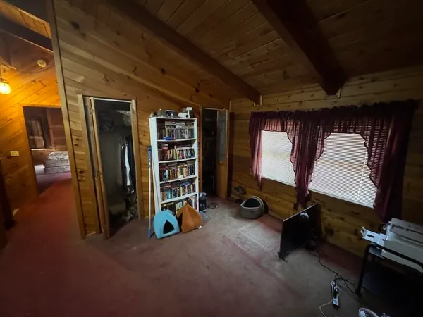 a bed sitting in a bedroom next to a window