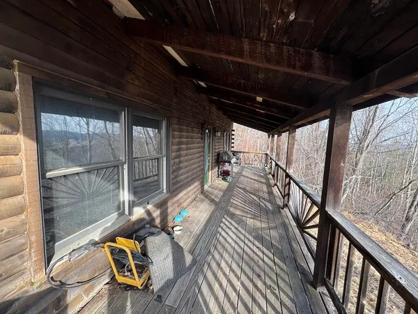 a view of yard covered with snow in front of house