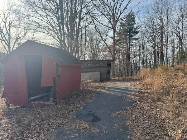 a view of a yard with wooden fence