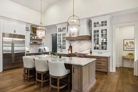 a living room with furniture a fireplace and a floor to ceiling window