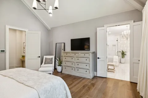 a bathroom with a sink a toilet a mirror and shower