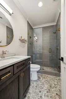 a living room with furniture a flat screen tv and a large window