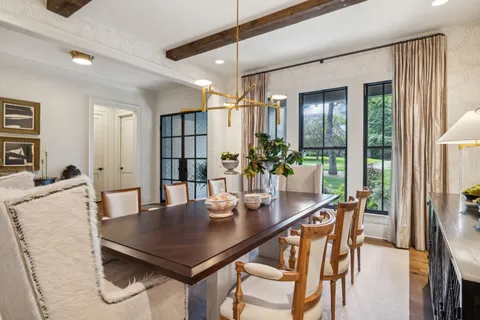 a living room with furniture kitchen and a table