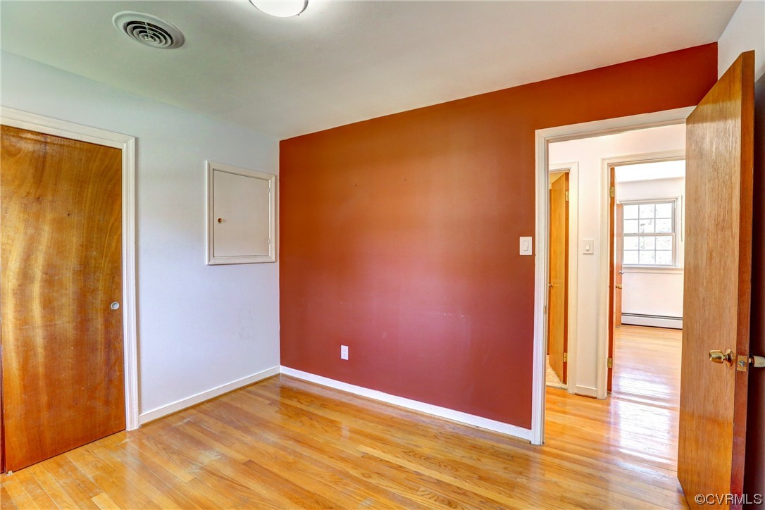 8207 Colebrook Road Richmond, VA 23227 - Photo 14 of 35 a view of an empty room with wooden floor and a window