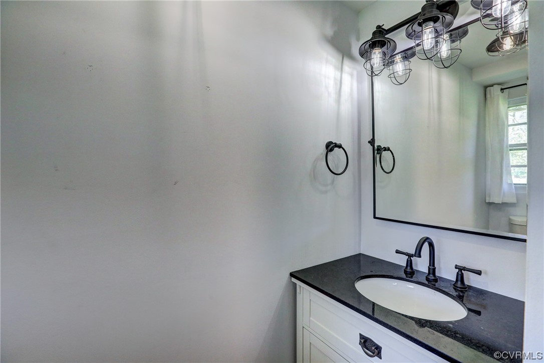 8207 Colebrook Road Richmond, VA 23227 - Photo 23 of 35 a bathroom with a granite countertop sink a mirror and a shower