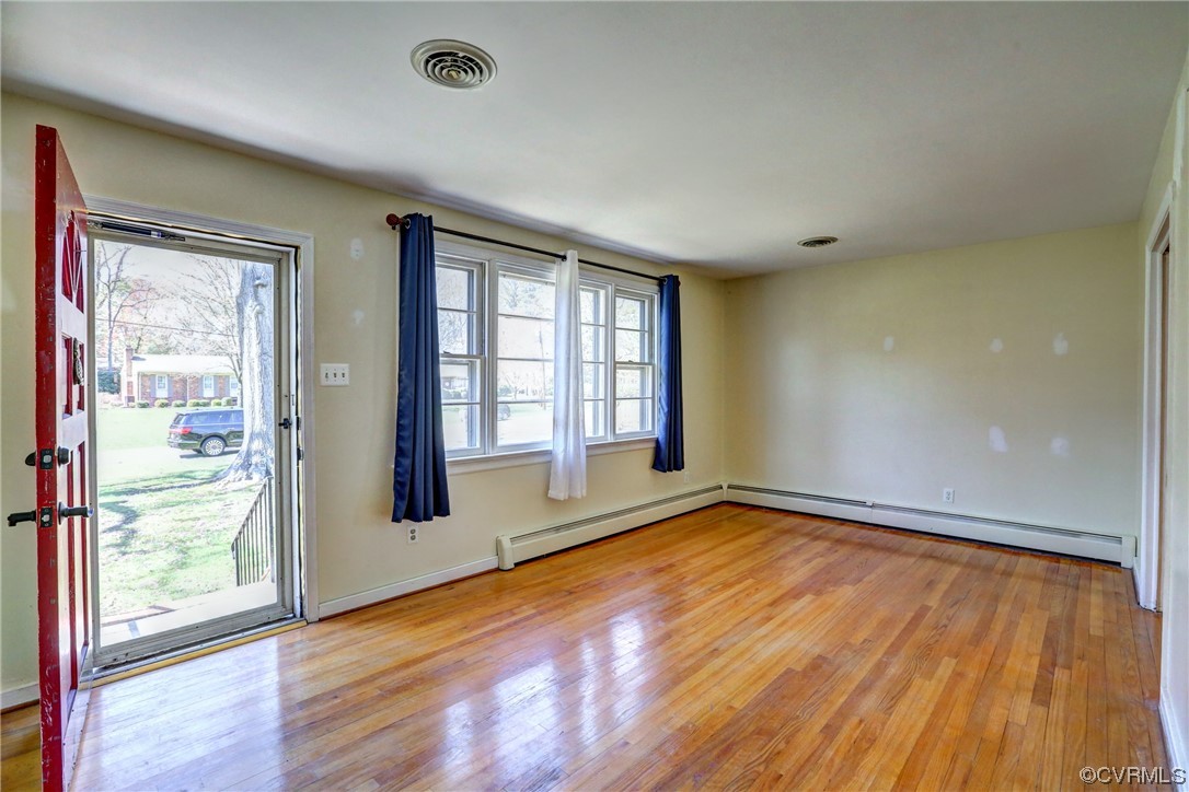 8207 Colebrook Road Richmond, VA 23227 - Photo 4 of 35 an empty room with wooden floor and windows
