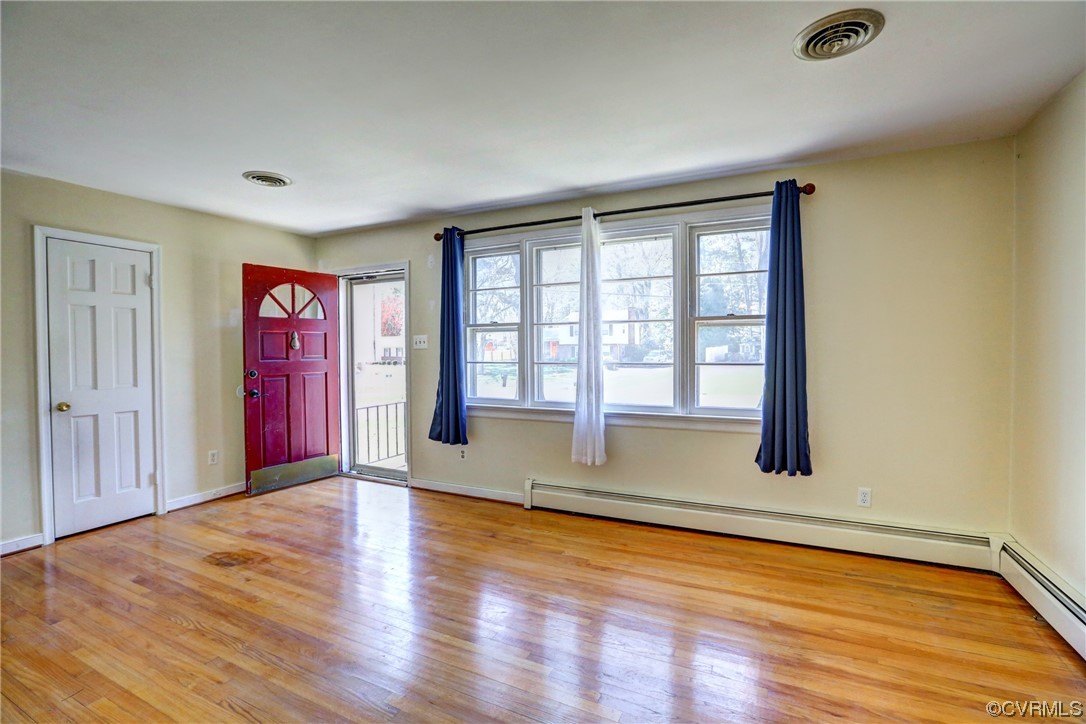 8207 Colebrook Road Richmond, VA 23227 - Photo 5 of 35 a view of an empty room with window and wooden floor