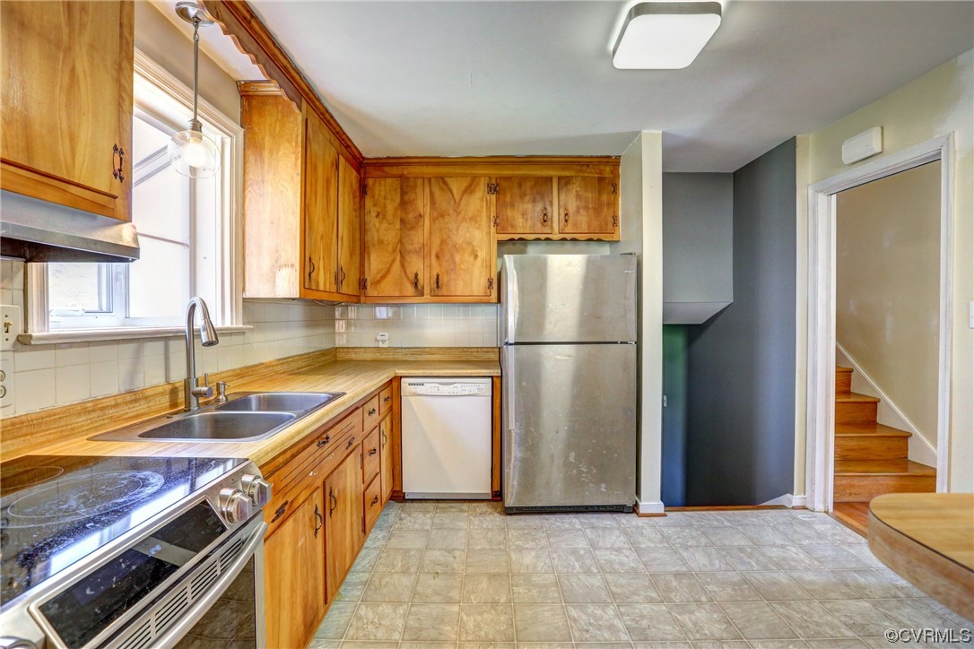 8207 Colebrook Road Richmond, VA 23227 - Photo 8 of 35 a kitchen with a refrigerator a sink and a cabinets
