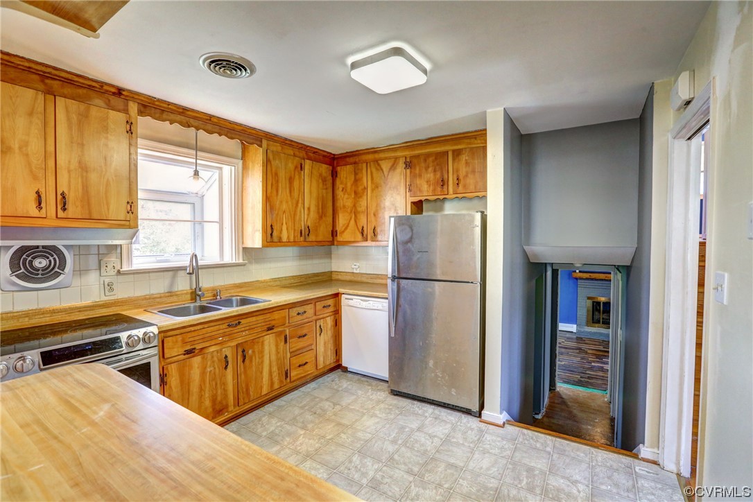 8207 Colebrook Road Richmond, VA 23227 - Photo 9 of 35 a kitchen with stainless steel appliances granite countertop a refrigerator and a sink