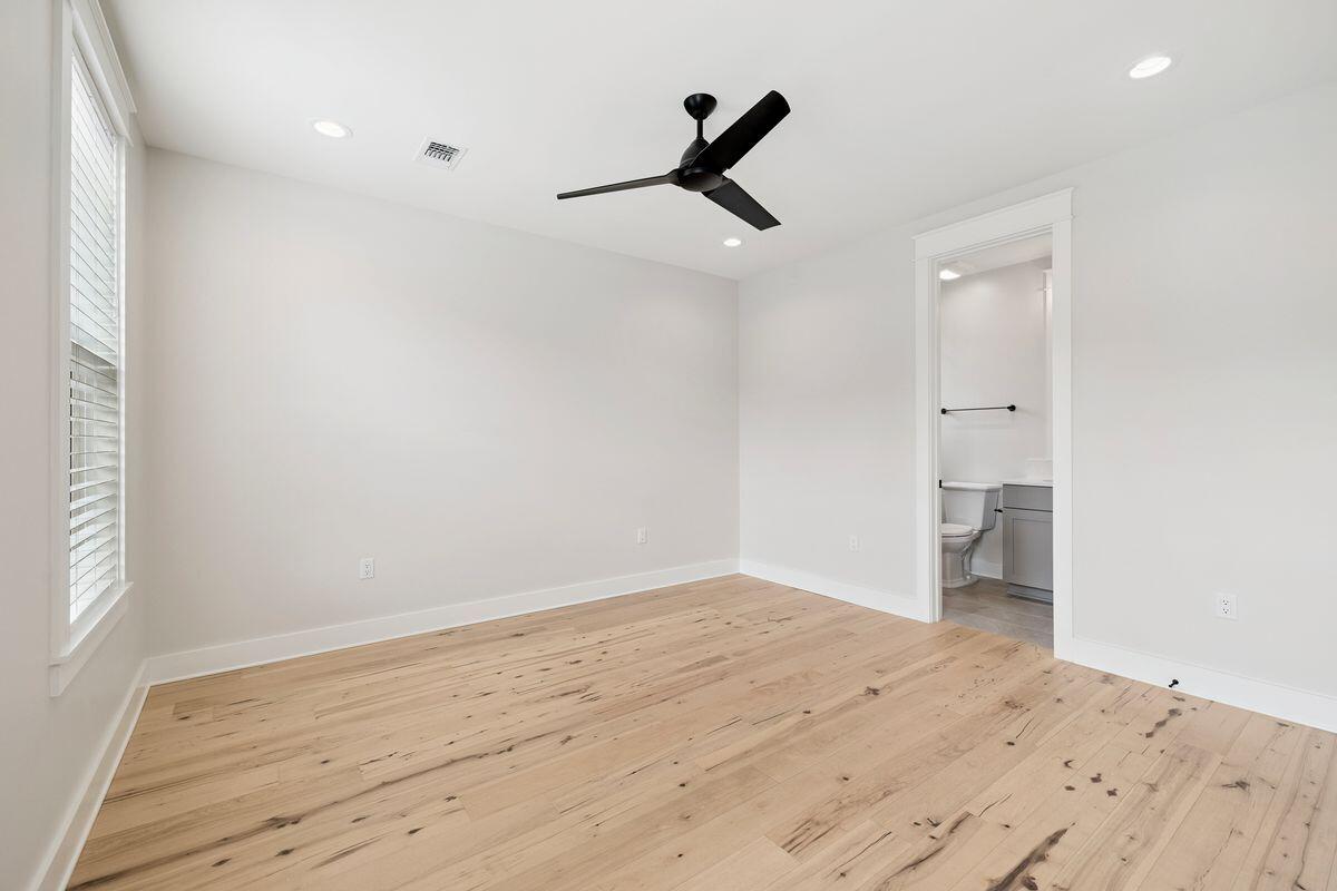 414 Ridgewalk Circle Santa Rosa Beach, FL 32459 - Photo 24 of 47 a view of empty room with wooden floor and ceiling fan