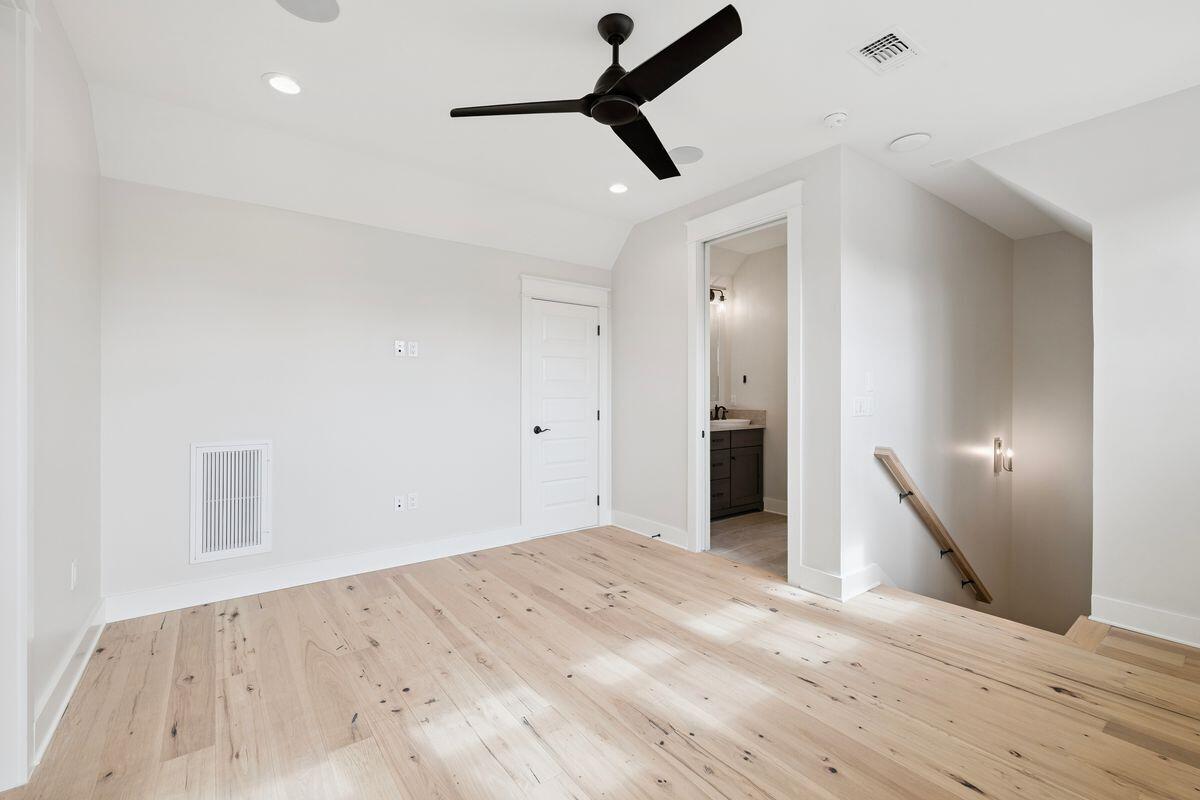414 Ridgewalk Circle Santa Rosa Beach, FL 32459 - Photo 31 of 47 a view of a big room with wooden floor and a ceiling fan