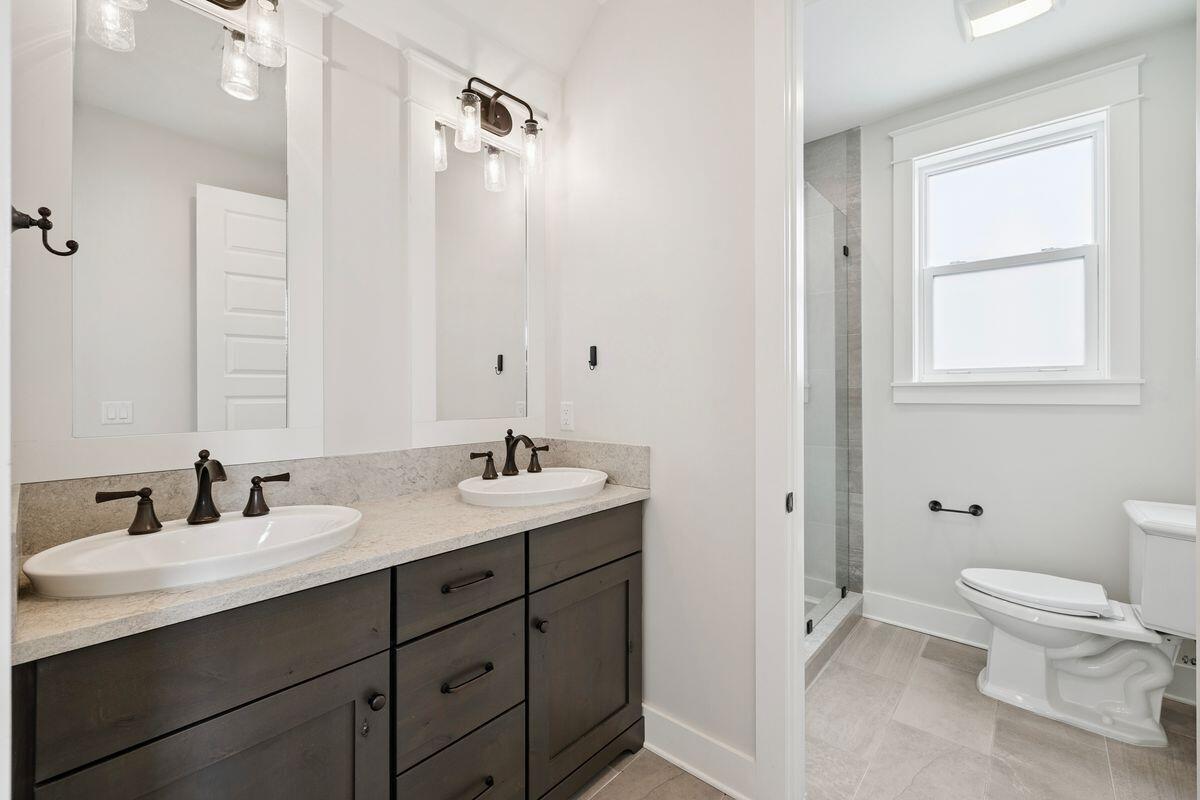 414 Ridgewalk Circle Santa Rosa Beach, FL 32459 - Photo 36 of 47 a bathroom with a granite countertop sink toilet and shower