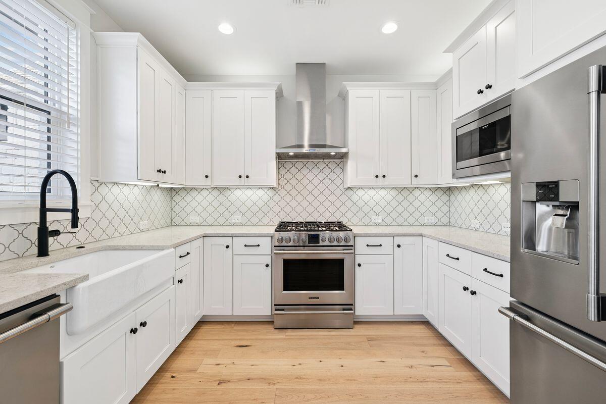 414 Ridgewalk Circle Santa Rosa Beach, FL 32459 - Photo 6 of 47 a kitchen with stainless steel appliances granite countertop white cabinets a stove a sink and dishwasher