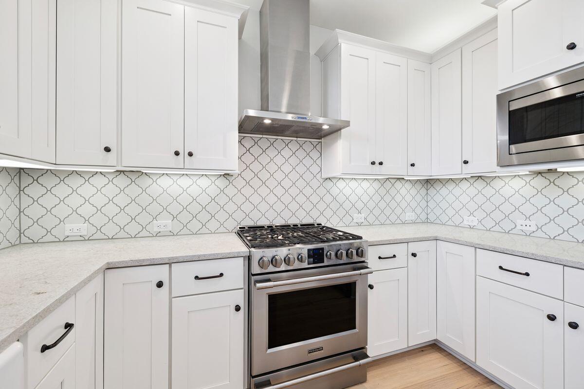 414 Ridgewalk Circle Santa Rosa Beach, FL 32459 - Photo 8 of 47 a kitchen with granite countertop white cabinets and stainless steel appliances
