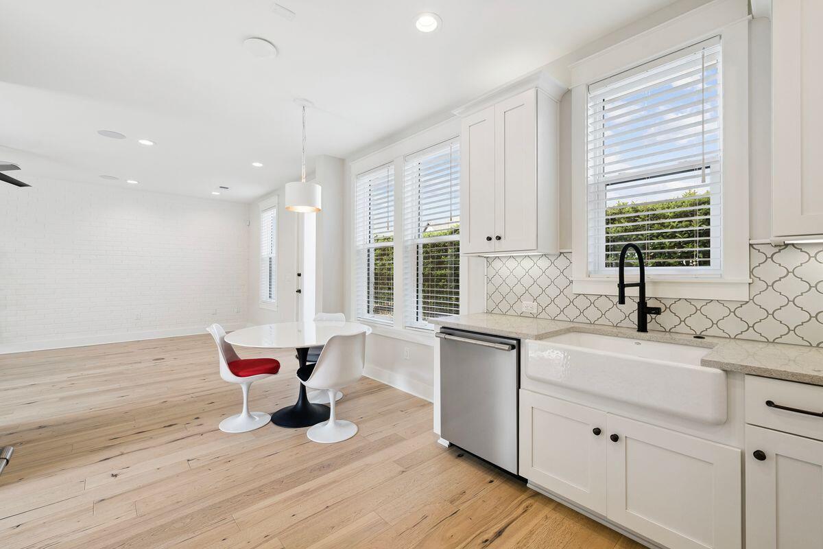 414 Ridgewalk Circle Santa Rosa Beach, FL 32459 - Photo 10 of 47 a kitchen with a sink cabinets wooden floor and a window