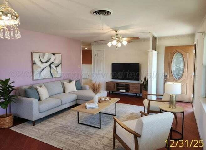 a living room with furniture a rug and a flat screen tv