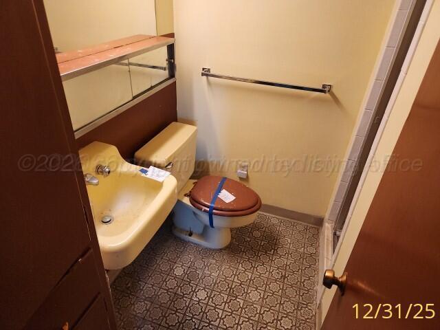 3401 Sunlite Street Amarillo, TX 79109 - Photo 14 of 26 a bathroom with a toilet and a shower