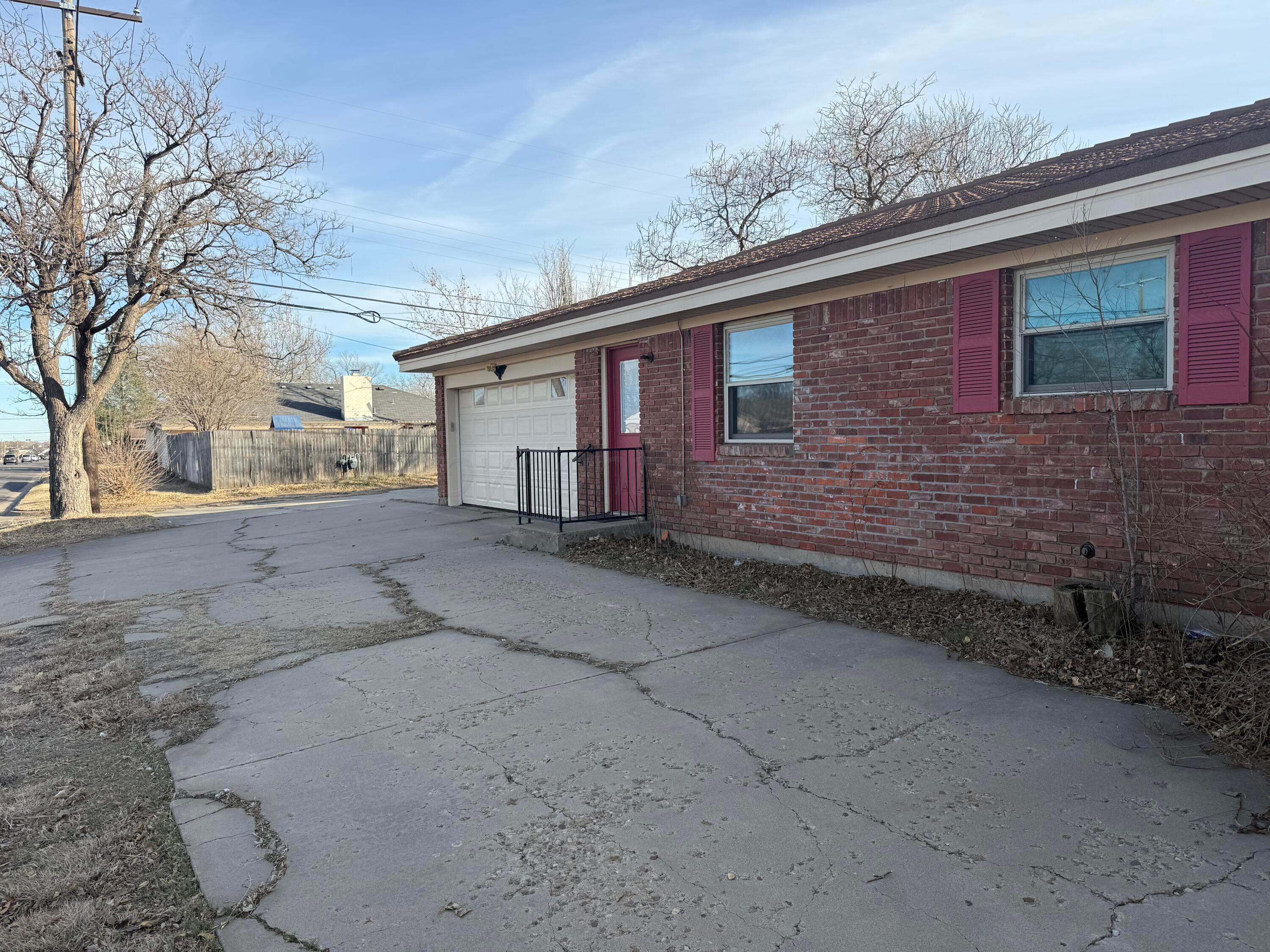 3401 Sunlite Street Amarillo, TX 79109 - Photo 24 of 26 a front view of a house with large trees