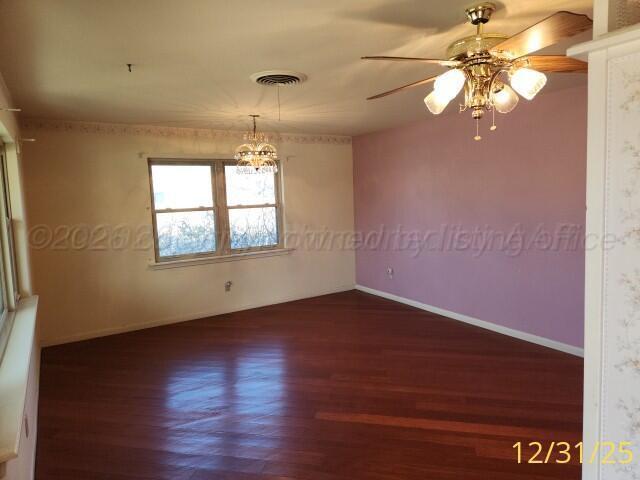 3401 Sunlite Street Amarillo, TX 79109 - Photo 4 of 26 wooden floor in an empty room with a window