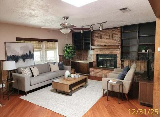 3401 Sunlite Street Amarillo, TX 79109 - Photo 7 of 26 a living room with furniture and a fireplace
