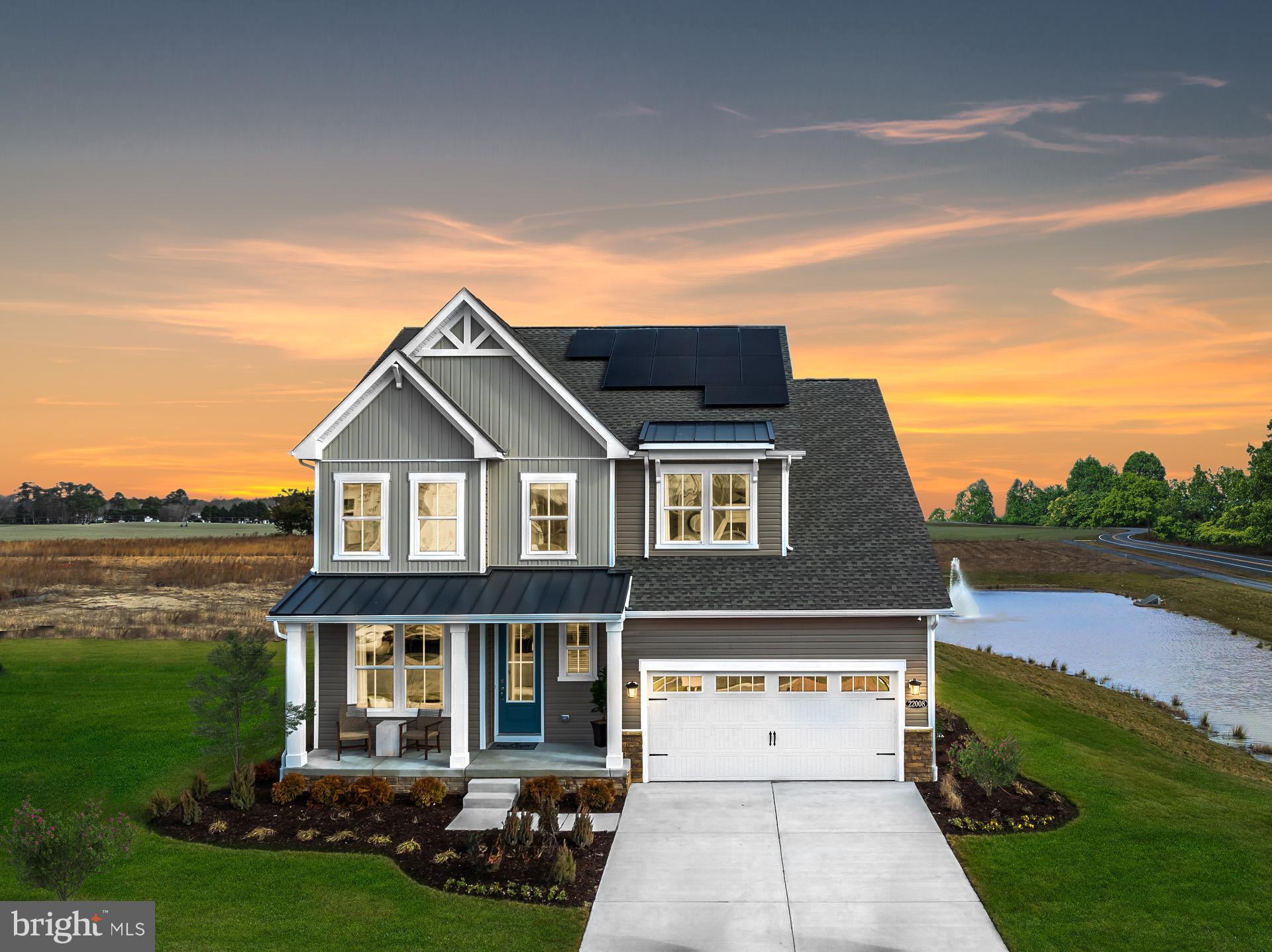 24692 Michael Isler Avenue Millsboro, DE 19966 - Photo 2 of 16 a front view of a house with garden