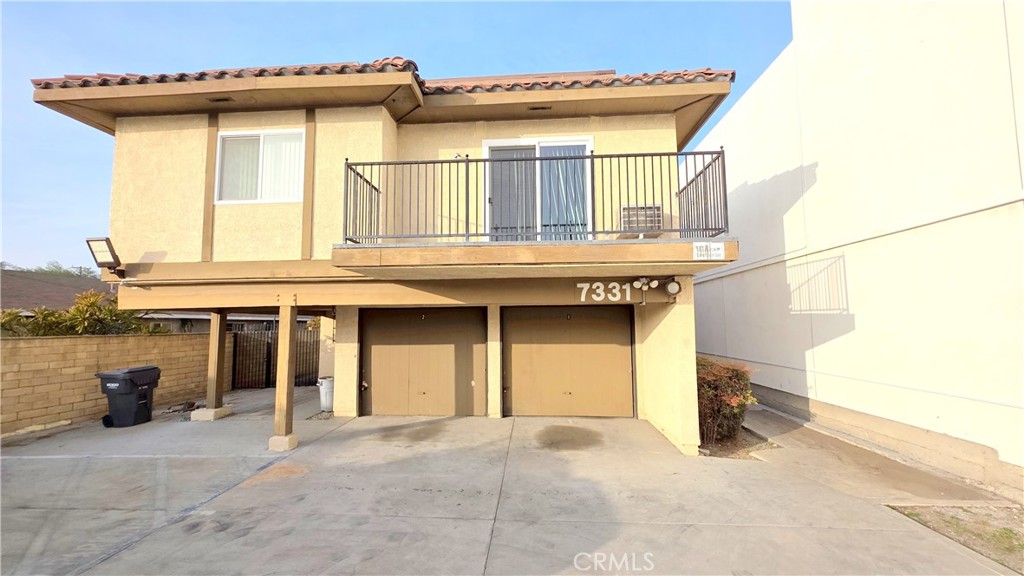 7331 9th Street, Unit 2 Buena Park, CA 90621 - Photo 1 of 19 a front view of a house with a garage