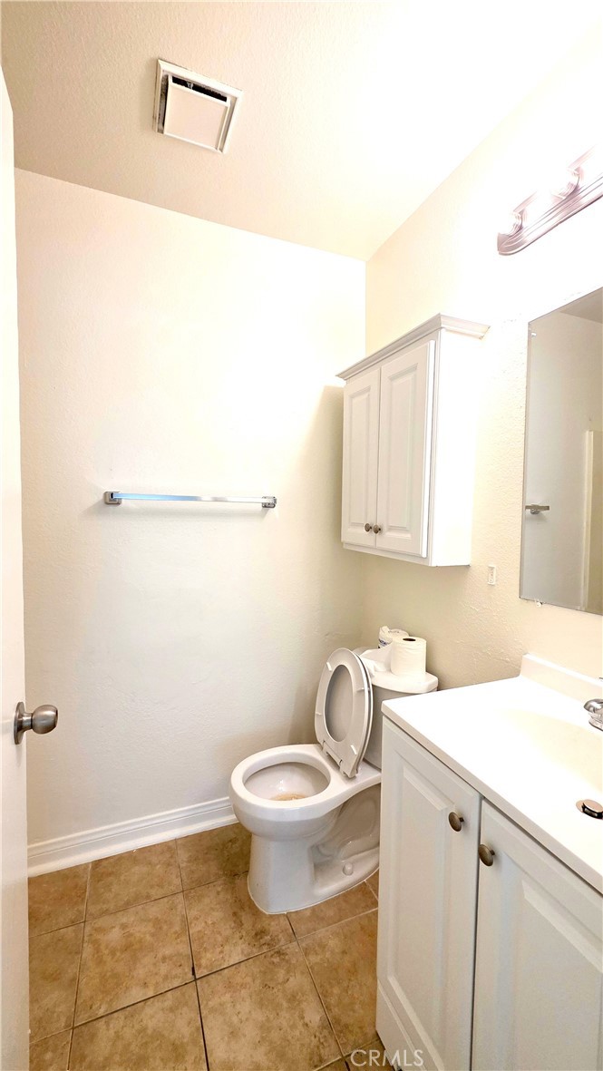 7331 9th Street, Unit 2 Buena Park, CA 90621 - Photo 15 of 19 a bathroom with a granite countertop sink a toilet and mirror