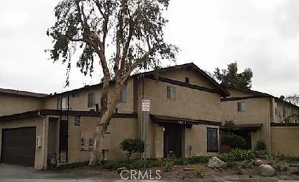 a front view of a house with plants
