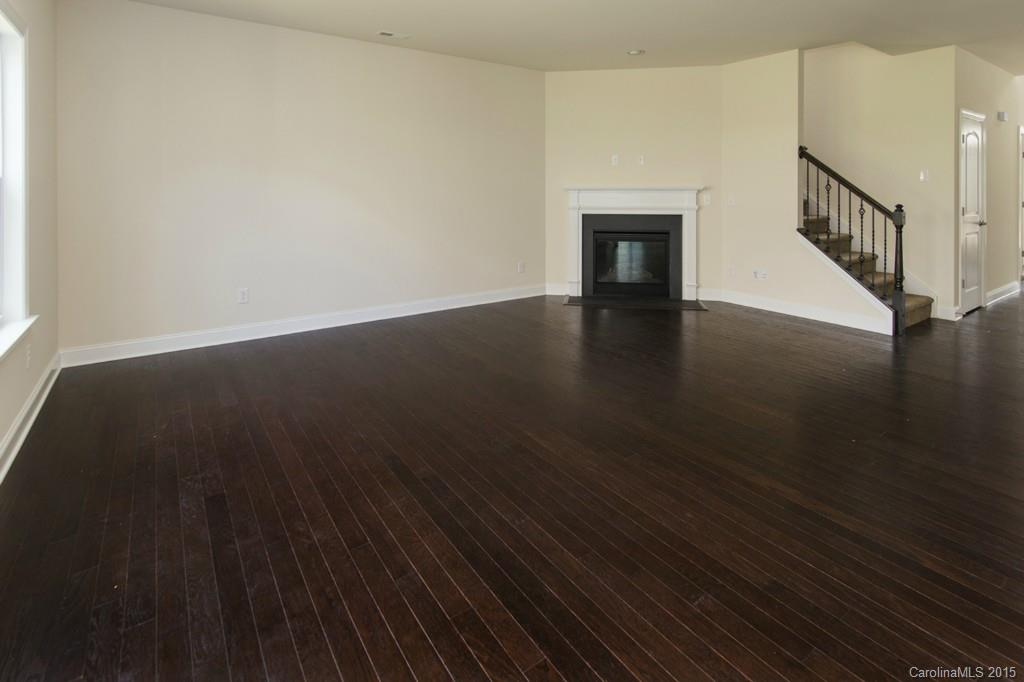 86524 Arrington Road, Unit 48 Lancaster, SC 29720 - Photo 3 of 19 a view of a livingroom with wooden floor and a fireplace