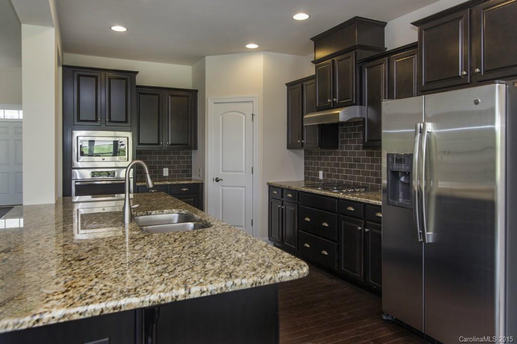 86524 Arrington Road, Unit 48 Lancaster, SC 29720 - Photo 8 of 19 a kitchen with stainless steel appliances granite countertop a refrigerator and a sink