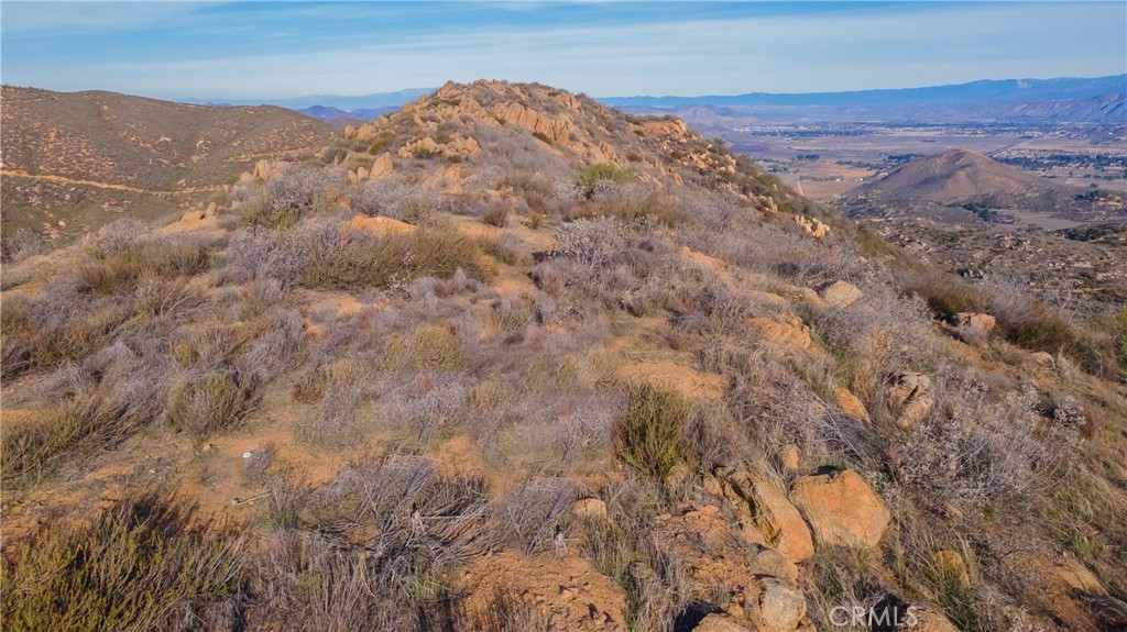 0 Lawghlin Road Hemet, CA 92543 - Photo 18 of 19 a view of a dry yard with mountains in the background