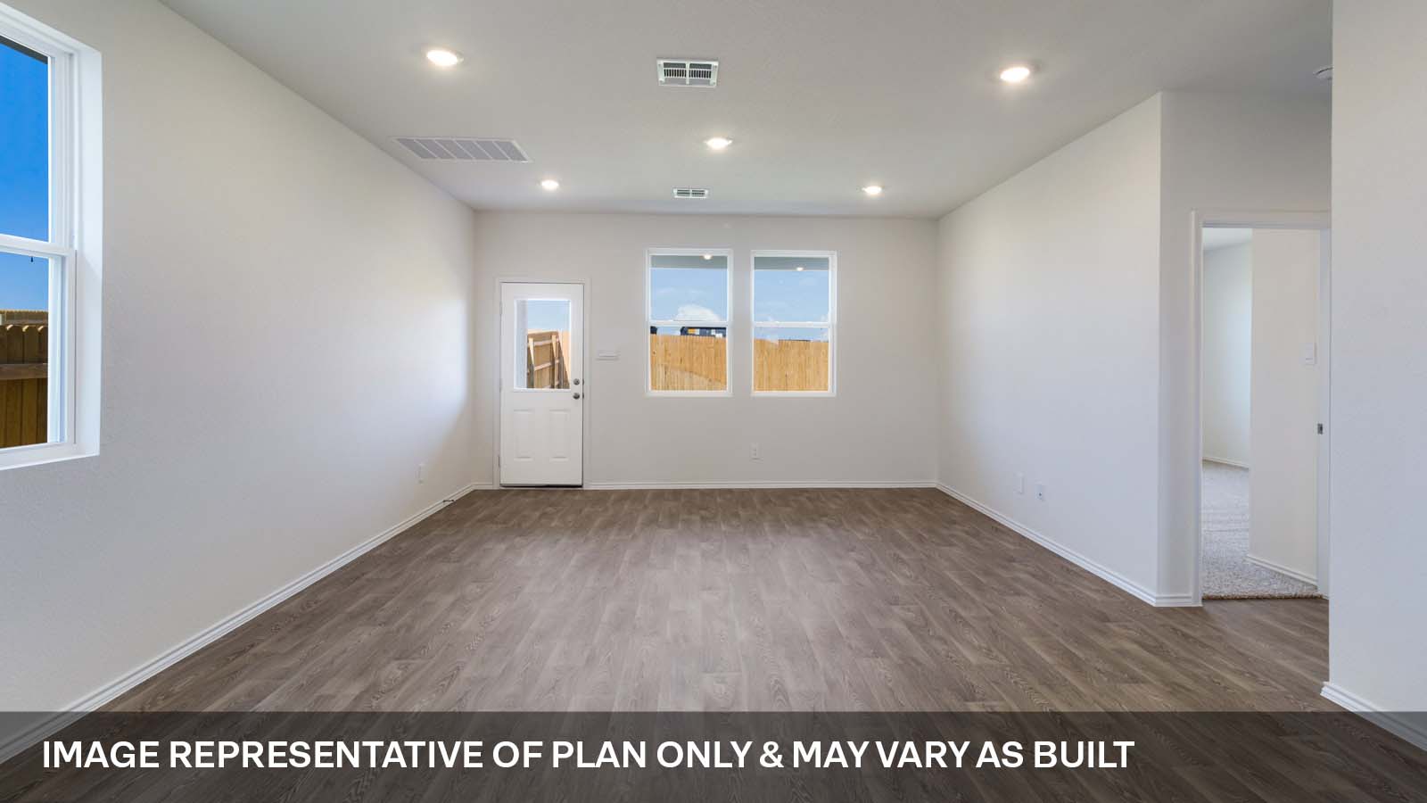 1173 Celosia Loop Kyle, TX 78640 - Photo 6 of 15 an empty room with wooden floor and windows