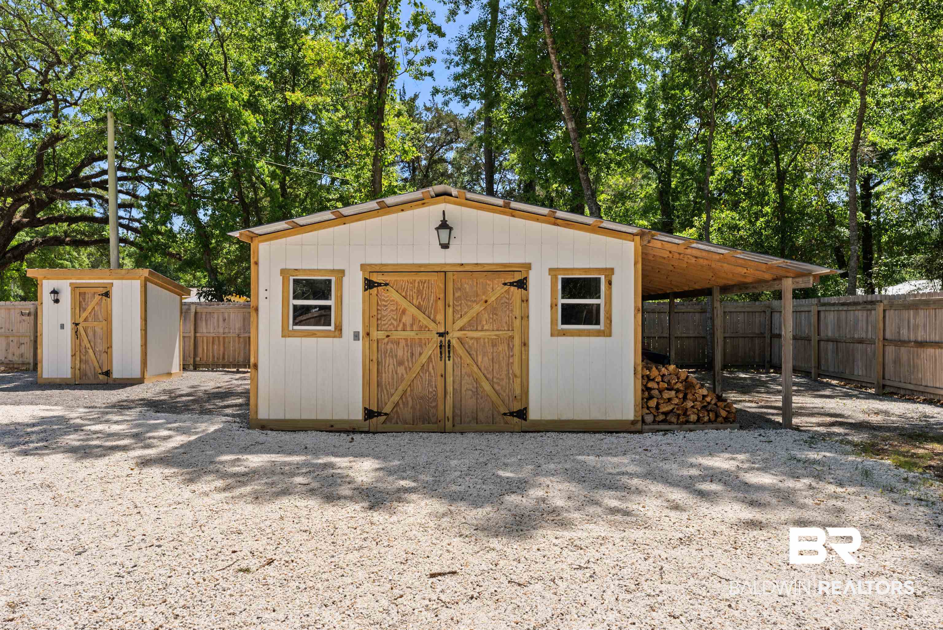 6447 Bemis Lane Bon Secour, AL 36511 - Photo 56 of 62 Two white storage sheds with natural wood doors and trim