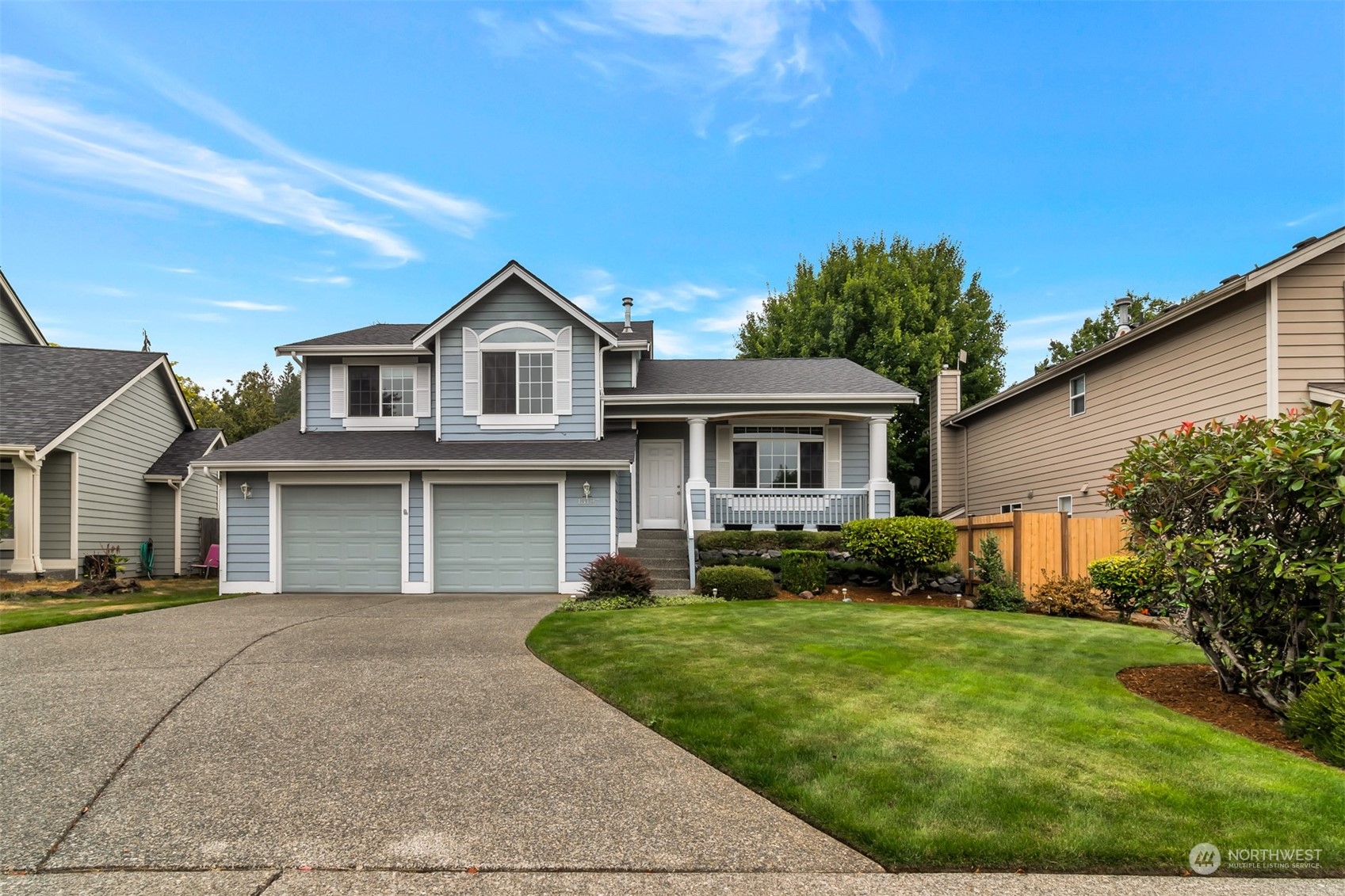 13197 Icicle Ridge Road Southeast Monroe, WA 98272 - Photo 1 of 25 a front view of a house with a yard and garage