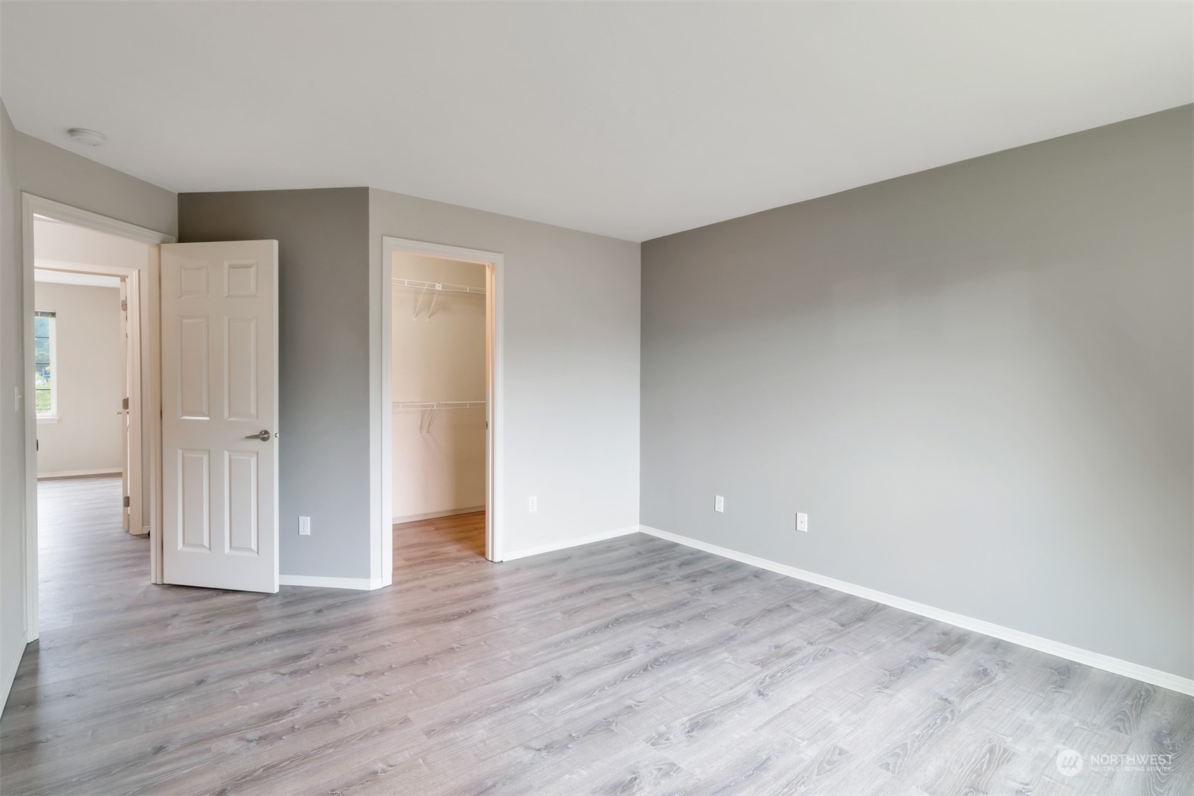 13197 Icicle Ridge Road Southeast Monroe, WA 98272 - Photo 13 of 25 a view of an empty room with wooden floor and window