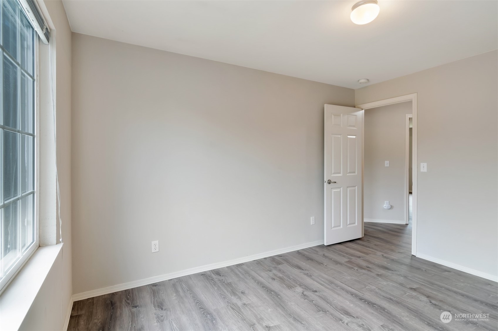 13197 Icicle Ridge Road Southeast Monroe, WA 98272 - Photo 16 of 25 a view of an empty room and wooden floor