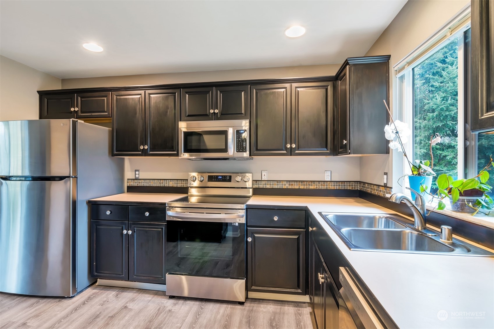 13197 Icicle Ridge Road Southeast Monroe, WA 98272 - Photo 3 of 25 a kitchen with a refrigerator sink and stove